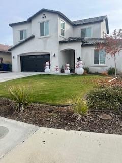 view of front of home with a garage and a front yard