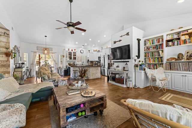 living area with lofted ceiling, a ceiling fan, recessed lighting, and wood finished floors