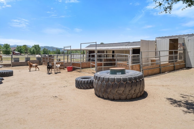 view of yard featuring an exterior structure, an outbuilding, and a mountain view