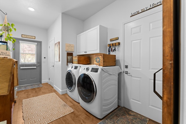 laundry area with separate washer and dryer, cabinet space, light wood finished floors, baseboards, and recessed lighting