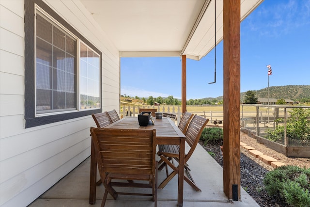view of patio featuring a garden and outdoor dining area
