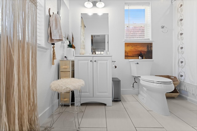 bathroom featuring toilet, baseboards, tile patterned flooring, vanity, and a shower with curtain