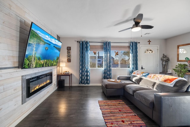 living room with dark hardwood / wood-style flooring and ceiling fan