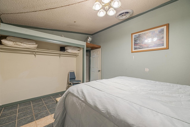 bedroom featuring a closet, crown molding, a textured ceiling, and vaulted ceiling