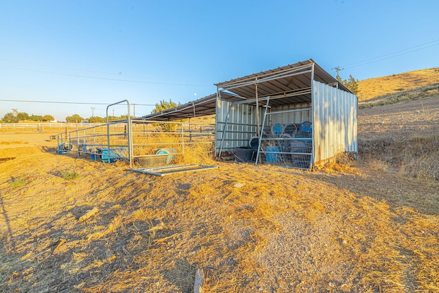 view of outdoor structure with a rural view