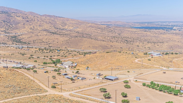 drone / aerial view featuring a mountain view and a rural view