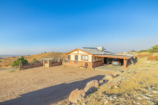 rear view of house featuring a carport