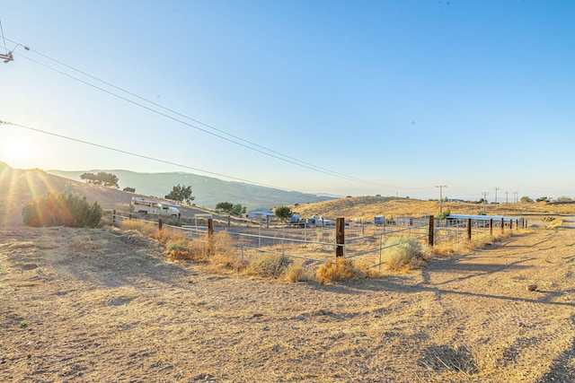 view of yard with a mountain view and a rural view