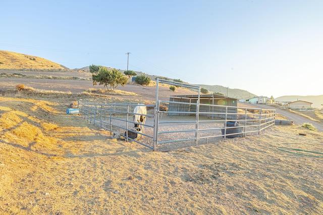 view of yard with an outbuilding and a rural view