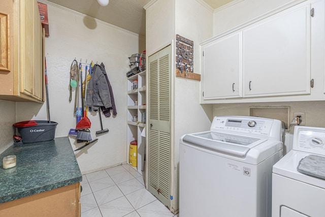 laundry room featuring cabinets, washer and dryer, and light tile patterned flooring