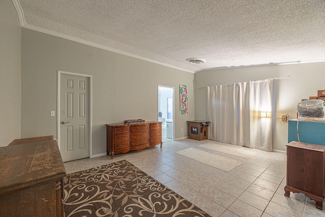 interior space featuring ensuite bath, a textured ceiling, and ornamental molding