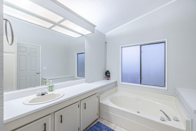 bathroom with tile patterned floors, a bathtub, lofted ceiling, and vanity