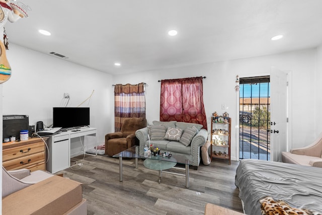 bedroom with recessed lighting, wood finished floors, visible vents, and access to exterior