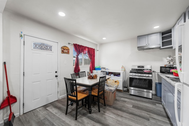 dining room with recessed lighting, baseboards, and wood finished floors