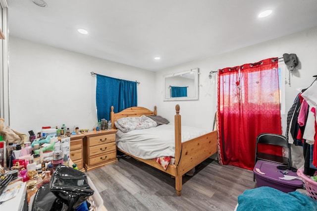 bedroom featuring wood finished floors and recessed lighting