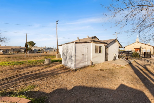 view of outdoor structure with fence and central AC unit