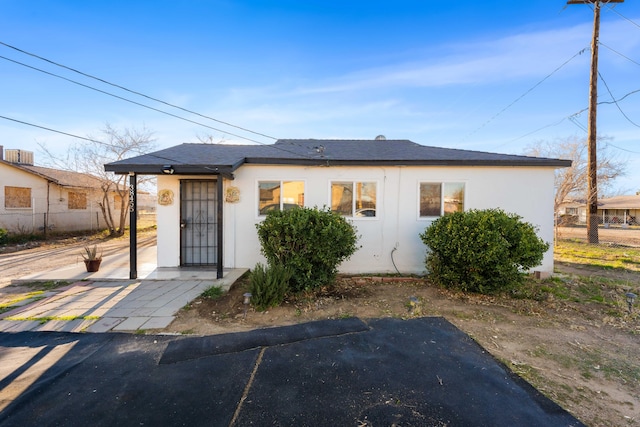 bungalow-style house with stucco siding