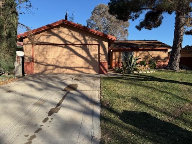 view of front of home with a garage and a front yard