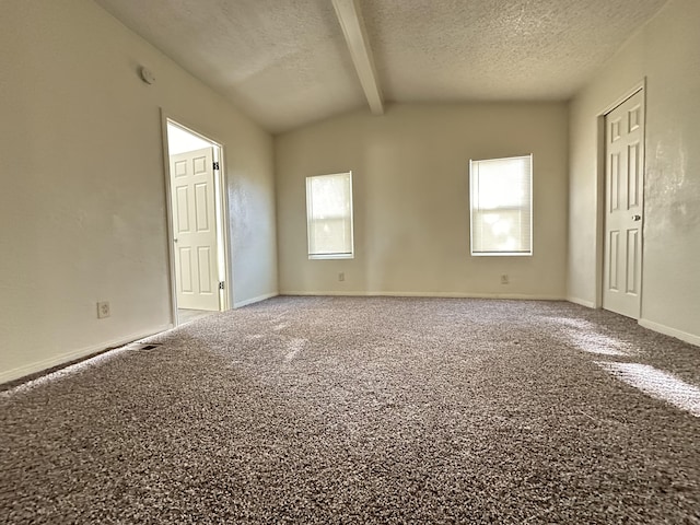 carpeted spare room featuring vaulted ceiling with beams and a textured ceiling