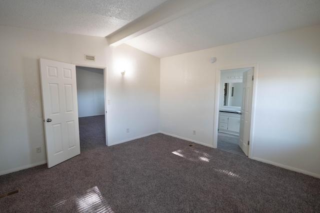 carpeted empty room featuring vaulted ceiling with beams and a textured ceiling