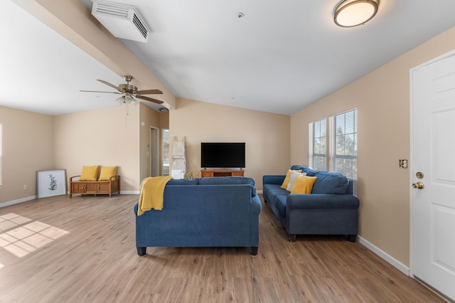 living room featuring ceiling fan, lofted ceiling, and light wood-type flooring