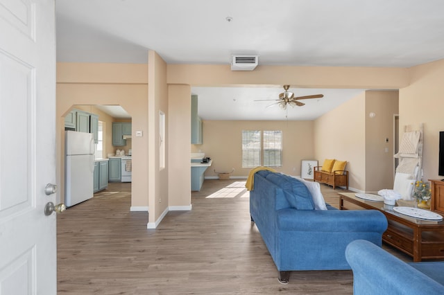 living room with hardwood / wood-style flooring and ceiling fan