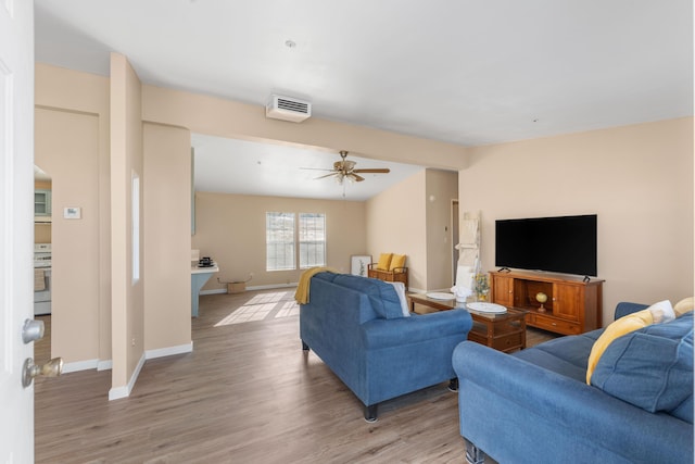 living room with light hardwood / wood-style flooring and ceiling fan