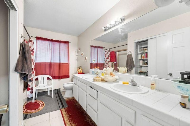 bathroom with tile patterned floors, vanity, and toilet