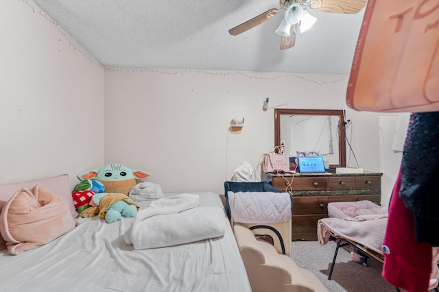 bedroom featuring ceiling fan, carpet, and a textured ceiling