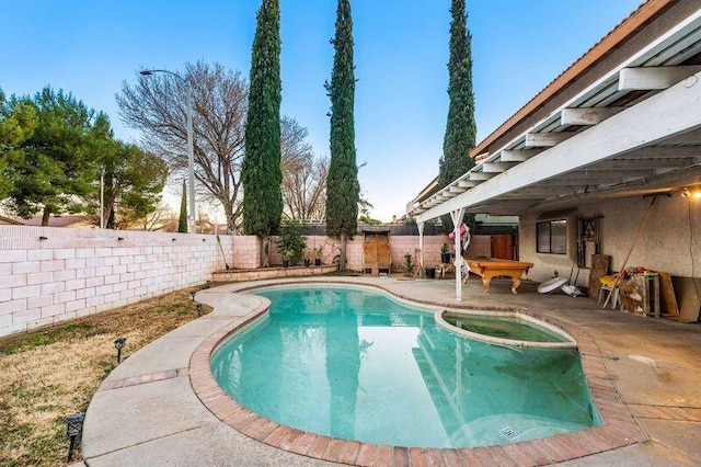 view of swimming pool with a patio area and an in ground hot tub