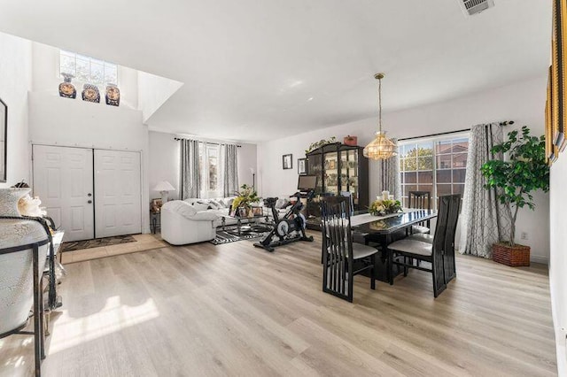 dining area with a chandelier and light hardwood / wood-style floors