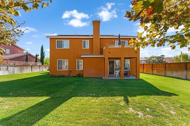 back of property featuring a lawn and a patio