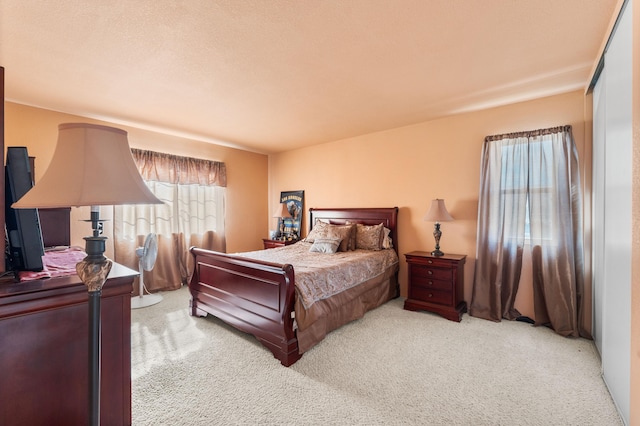 bedroom featuring light colored carpet