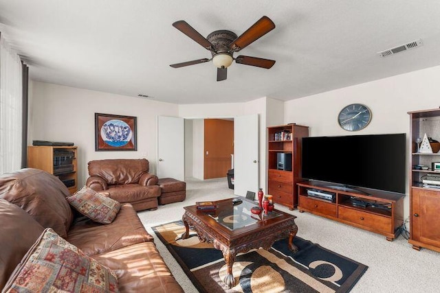 carpeted living room featuring ceiling fan