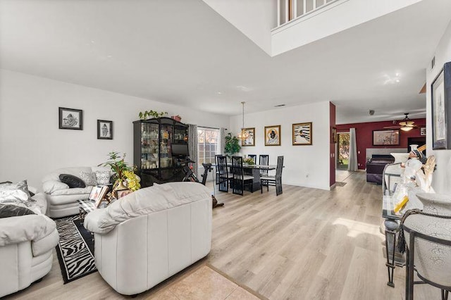 living room with light wood-type flooring and ceiling fan