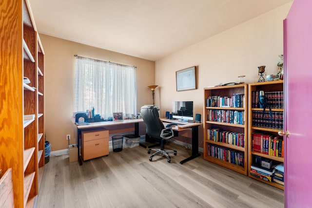 home office with light hardwood / wood-style floors