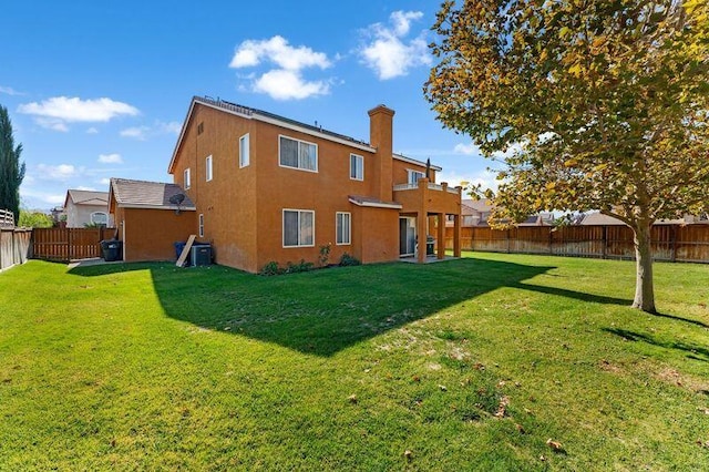 back of house featuring a yard