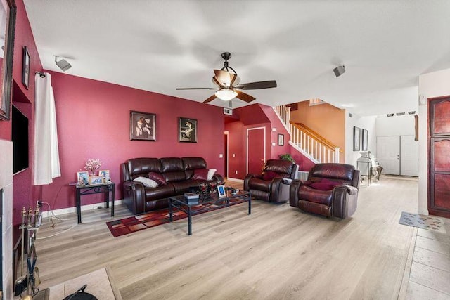 living room featuring light hardwood / wood-style floors and ceiling fan