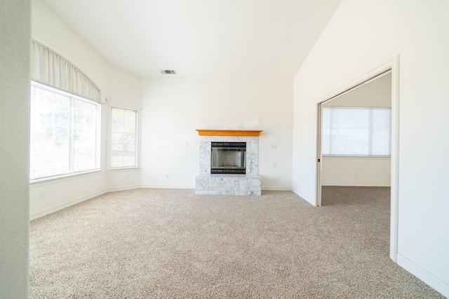 unfurnished living room featuring a fireplace and light colored carpet