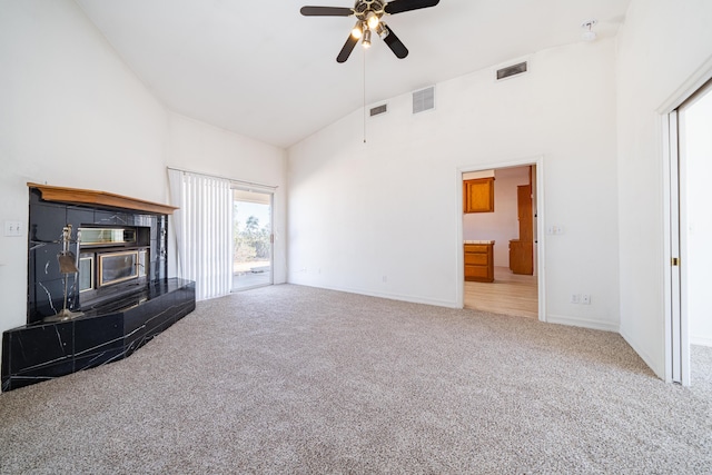 unfurnished living room featuring ceiling fan, carpet floors, and high vaulted ceiling