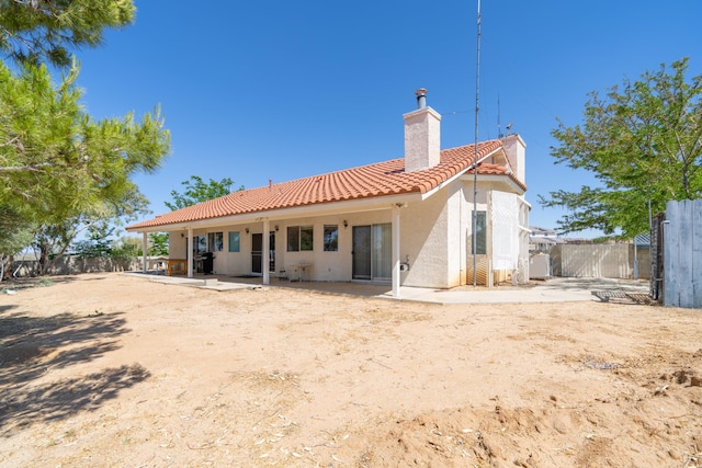 rear view of property featuring a patio area