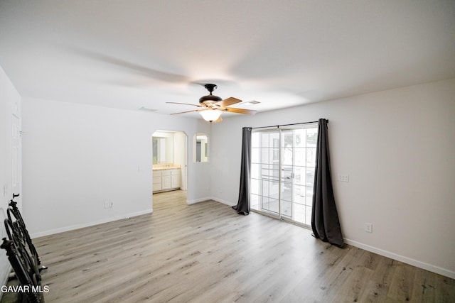 3807 Paula Ln, Lancaster, CA 93535 - empty room featuring light wood finished floors, arched walkways, and ceiling fan