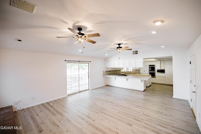 3807 Paula Ln, Lancaster, CA 93535 - unfurnished living room featuring vaulted ceiling, a ceiling fan, light wood-type flooring, and recessed lighting