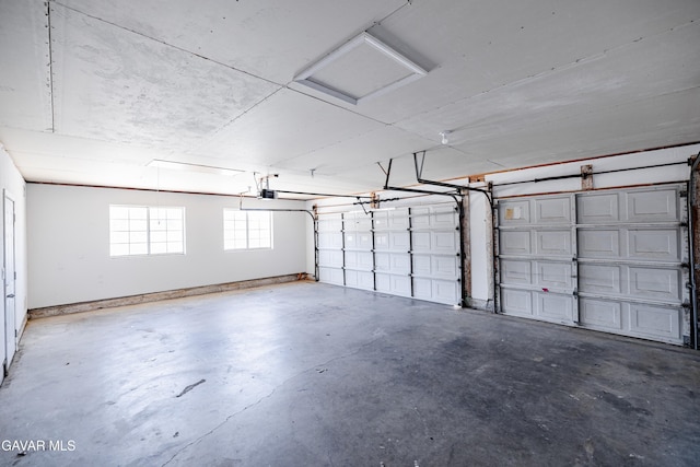 3807 Paula Ln, Lancaster, CA 93535 - garage featuring a garage door opener and baseboards