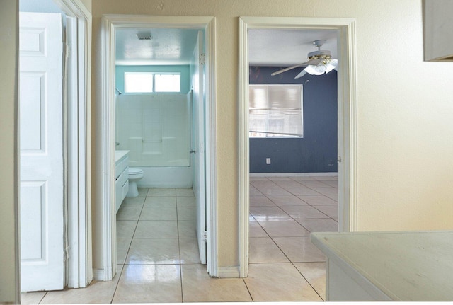 hall featuring light tile patterned flooring