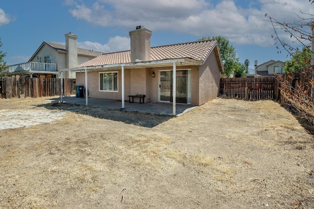 back of property with a patio