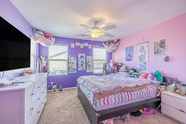 bedroom with light colored carpet and a ceiling fan