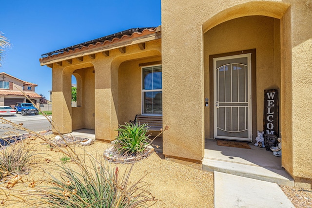 doorway to property with stucco siding