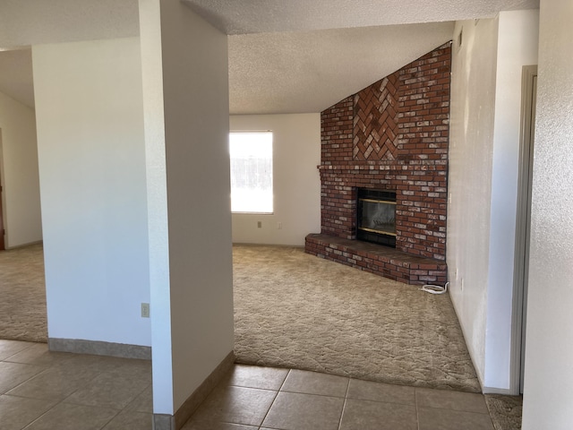 unfurnished living room with a fireplace, a textured ceiling, light colored carpet, and vaulted ceiling