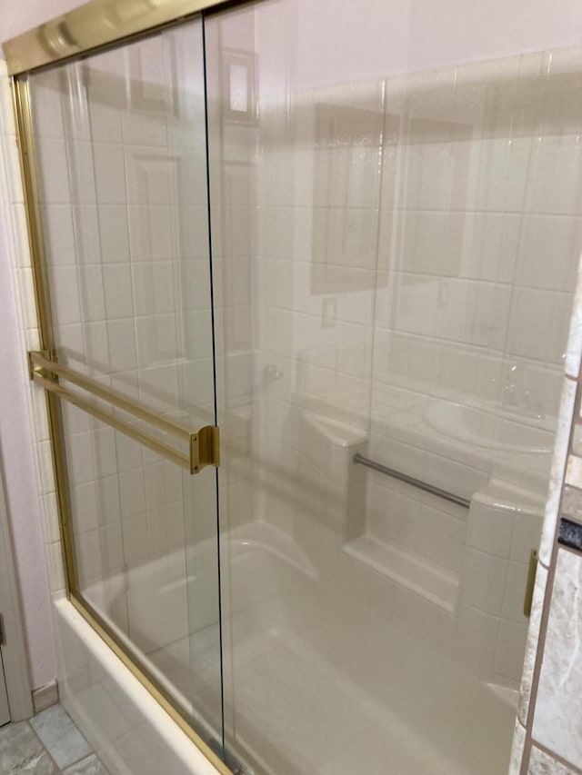 bathroom featuring tile patterned floors and enclosed tub / shower combo